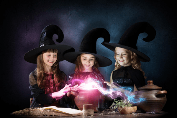 Solar Halloween lights enchant three cute little witches at their cauldron